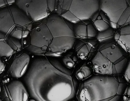Black and white closeup photograph of a cluster of bubbles.