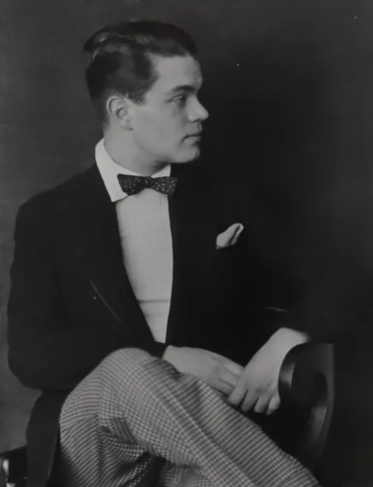 Black and white photograph of a man in a suit looking to the right.