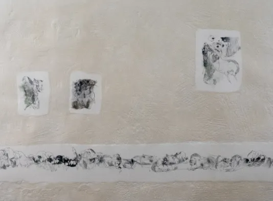 Four piece of paper cut out onto a wall with small ink blotches on each.